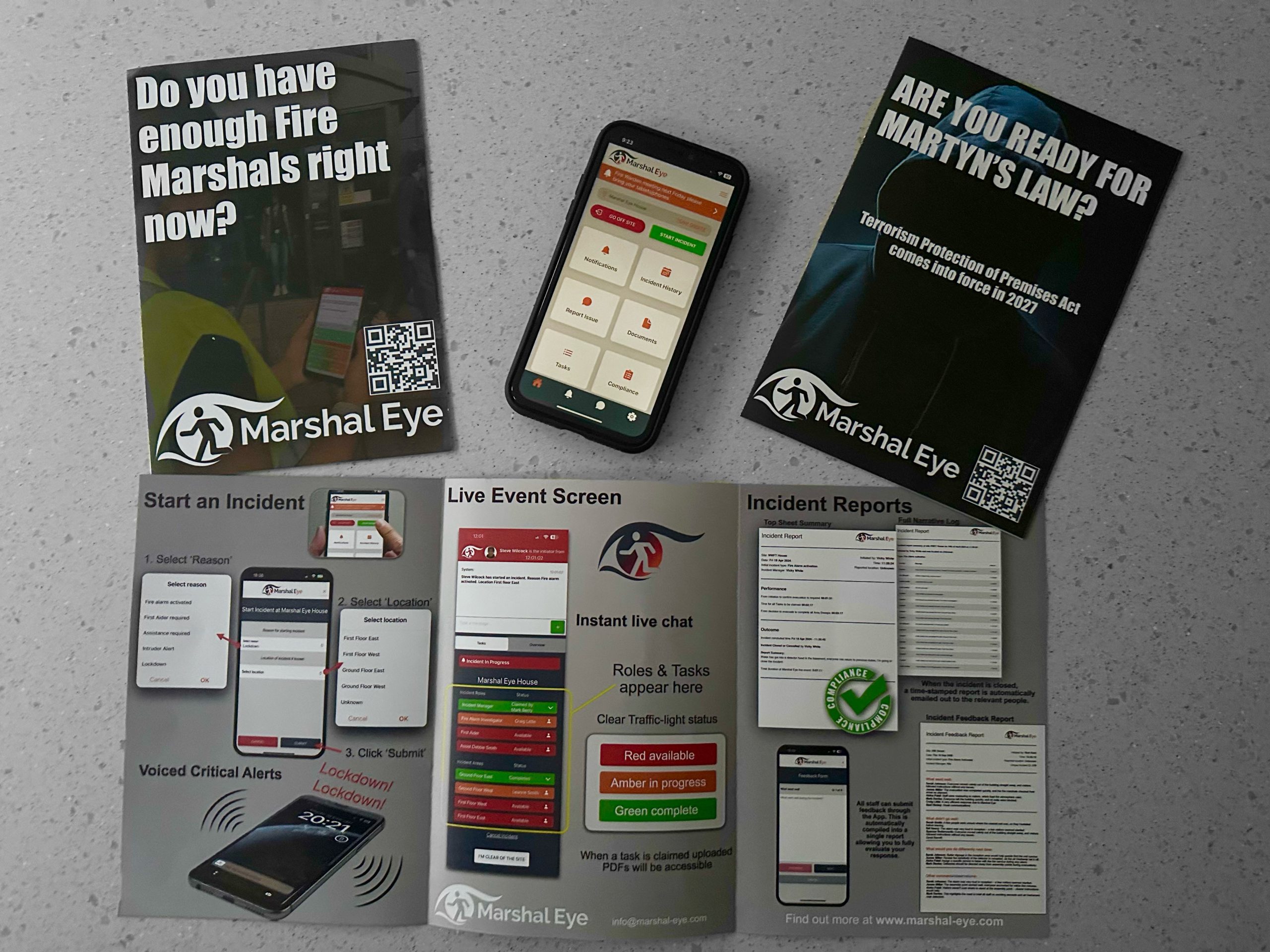 Marshal Eye fire safety app leaflets showing Fire Marshal coordination features, Martyn’s Law readiness leaflet, and the live incident screen next to a smartphone using the Marshal Eye app.